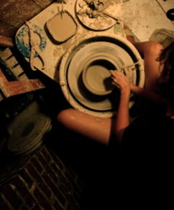 A potter in Memphis, Tennessee shapes a piece of pottery on a variable-speed, electric-powered potter's wheel