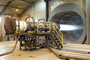A Pratt & Whitney F100 turbofan engine for the F-15 Eagle and the F-16 Falcon is tested at Robins Air Force Base, Georgia, USA. The tunnel behind the engine muffles noise and allows exhaust to escape