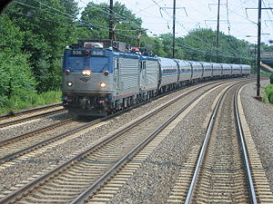 An electric Amtrak train with two AEM-7 locomotives running through New Jersey on the Northeast Corridor.