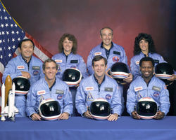 The crew of STS-51-L. Front row, from left to right: Michael J. Smith, Dick Scobee, and Ronald McNair. Back row, from left to right: Ellison Onizuka, Christa McAuliffe, Gregory Jarvis, and Judith Resnik.