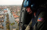 A U.S. Coast Guardsman searches for survivors in New Orleans in the aftermath of Katrina
