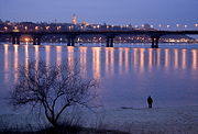 The city across the Dnieper River in the twilight.