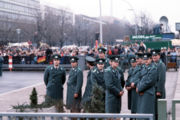 Police officers of the East German Volkspolizei wait for the official opening of the Brandenburg Gate on 22 December 1989.