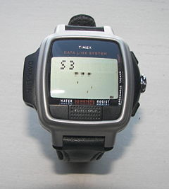 Timex Datalink USB Dress edition from 2003 with a dot matrix display; the Invasion video game is on the screen.