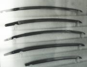 Several nihontō and wakizashi blades, illustrating the variations in length and curvature. The nakago are well visible.