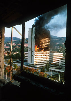 The parliament building in the centre of Sarajevo burns after being hit by tank fire during the siege in 1992.
