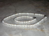 Inexpensive, button-shape cultured freshwater pearls used in a necklace and bracelet.
