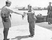 30 August 1945. Yokosuka Naval Base, Tokyo Bay. Commander Yuzo Tanno hands over the keys of Yokosuka Naval Base to Captain H. J. Buchanan, Royal Australian Navy. Buchanan led the first Commonwealth party to go ashore in Japan.