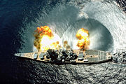 USS Iowa fires a full broadside of nine 16 inch (406 mm) / 50-caliber and six 5 inch (127 mm) / 38-caliber guns during a target exercise. Note concussion effects on the water surface, and 16 inch (406 mm) gun barrels in varying degrees of elevation.
