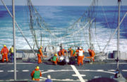 Crewmen recover an RQ-2 Pioneer Unmanned Aerial Vehicle aboard Iowa. Pioneer drones launched from the Iowa-class battleships were steered into a large net on the ships, where they were recovered by the crew.