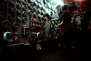 A crewman operates the ship's throttle in the main engine room aboard New Jersey.