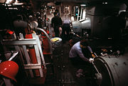 Crewmen operate the electrical generators in the upper level engine room aboard New Jersey.