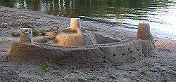 A simple sandcastle on a lake beach