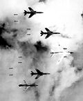 A U.S. EB-66 Destroyer and four F-105 Thunderchiefs dropping bombs on North Vietnam