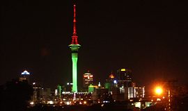 Sky Tower illuminated in Christmas colours during December.