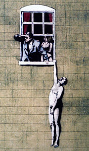 Naked Man image by Banksy, on the wall of a sexual health clinic 1in Park Street, Bristol, England. Following popular support, the City Council have decided it will be allowed to remain - (wider view).