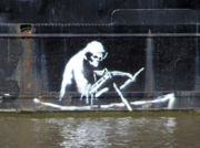 Stencil by Banksy on the waterline of The Thekla, an entertainment boat in central Bristol, England - (wider view).