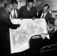The original architects of apartheid gathered around a map of a planned township.