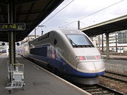 A TGV Duplex trainset coupled to a Reseau trainset leaving Paris Gare de Lyon.