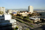 Downtown San Jose looking over the Tech Museum towards Mount Hamilton; hills in the background show their winter green color.