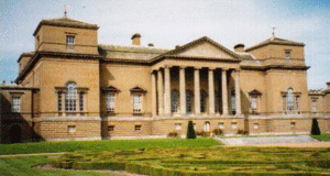 Holkham Hall. The severely Palladian south facade with its Ionic portico is devoid of arms or motif; not even a blind window is allowed to break the void between the windows and roof-line, while the lower windows are mere piercings in the stark brickwork. The only hint of ornamentation is from the two terminating Venetian windows.