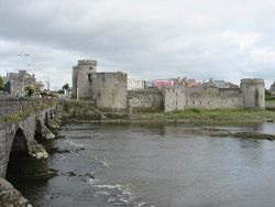 King John's Castle sits on the southern bank of the River Shannon. Alongside is Thomond Bridge.