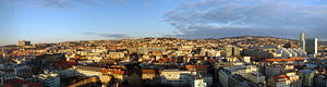 Panorama of the early morning sunshine over Bratislava's Old Town, to the left, and the New Town, to the right. Bratislava Castle is visible to the far left.