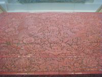 The only surviving piece of furniture from the "Orchard Factory" (the Imperial Lacquer Workshop) set up in Beijing in the early Ming Dynasty. Decorated in dragons and phoenixes, it was made during the Xuande era (1426–1435). The imperial workshops in the Ming era were overseen by a eunuch bureau. (See closeup for detail)