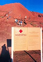 Climbers and a warning sign.
