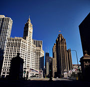 Looking north from the North Michigan Avenue Bridge on Chicago's 'Magnificent Mile'. The Wrigley Building  and Tribune Tower are in the foreground with the John Hancock Center in the distance.