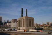 Steam generating station for adjacent railyard with downtown in background.