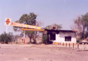 Abandoned, fire-damaged Whiting Brothers gas station, New Mexico. Conservation efforts are under way to preserve original buildings such as this all along the route.