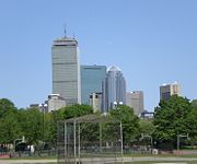 The skyline of Boston's Back Bay neighborhood, home to some of the city's tallest skyscrapers, as seen from the Back Bay Fens. The Prudential Tower, John Hancock Tower, 111 Huntington Avenue, and the Christian Science Center are all visible; left to right.