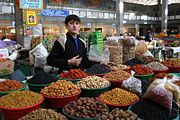 A boy selling dried fruit at a local market