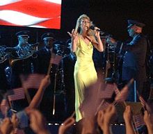 Dion singing "God Bless America" at a May 2, 2002 concert aboard the USS Harry S. Truman.