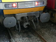 British-style dual buffer-and-chain/automatic coupler with knuckle swung out of the way