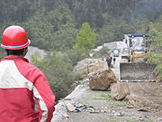 Persistent rain, as well as rock slides and a layer of mud coating on the main roads, such as the one above, hinders rescue official's efforts to enter the target region.