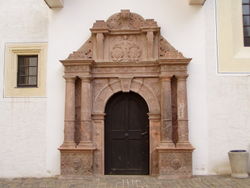 The porphyry mannerist portal of the church house carved by Andreas Walther II in 1584.