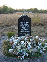 Memorial for Margot and Anne Frank at the former Bergen-Belsen site, along with floral and pictorial tributes