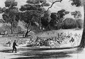 A game at the Richmond Paddock in the 1860s. A pavilion at the MCG is on the left in the background. (A wood engraving made by Robert Bruce on July 27, 1866.)