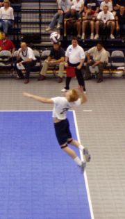 A man making a jump serve.