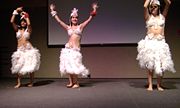 Polynesian dancing with feather costumes is on the tourist itinerary