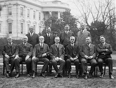 Coolidge's cabinet in 1924, outside the White HouseFront row, left to right: Harry Stewart New, John W. Weeks, Charles Evans Hughes, Coolidge, Andrew Mellon, Harlan F. Stone, Curtis D. Wilbur Back row, left to right, James J. Davis, Henry C. Wallace, Herbert Hoover, Hubert Work