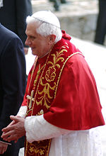 The Pope's mozetta has a hood forbidden for most other clergy.
