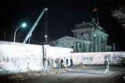 A crane removing a section of the Berlin Wall near Brandenburg Gate on December 21, 1989