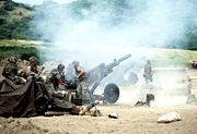 M102 howitzers firing during battle.