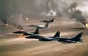 USAF aircraft (F-16, F-15C and F-15E) fly over Kuwaiti oil fires, set by the retreating Iraqi army during Operation Desert Storm in 1991.
