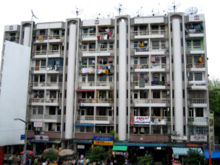 A block of flats in downtown Yangon, facing Bogyoke Market. Much of Yangon's urban population resides in densely-populated flats.