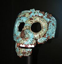 A jade mask. Its design metaphorically represents the Rain God Chaac, and the Creator God Kukulcán.