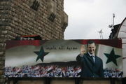 Billboard with portrait of Assad and the text God protects Syria on the old city wall of Damascus 2006.